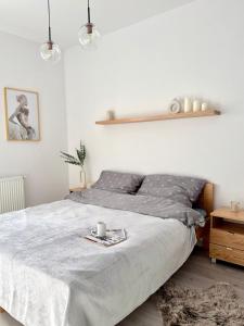 a bedroom with a bed with a tray on it at Apartament Stare Miasto 2 in Elblag
