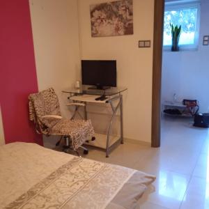 a bedroom with a desk with a computer and a chair at Ester in Będzin