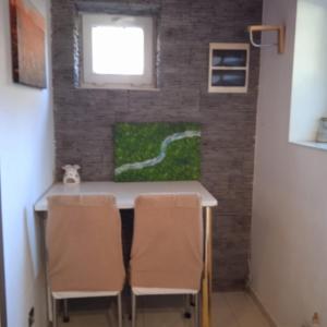 a room with a table and chairs and a brick wall at Ester in Będzin