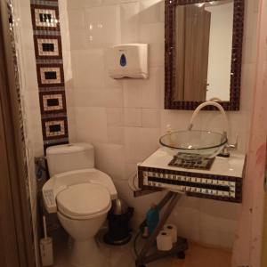 a bathroom with a sink and a toilet and a mirror at Ester in Będzin