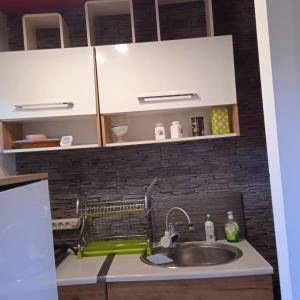 a kitchen with a sink and a counter top at Ester in Będzin