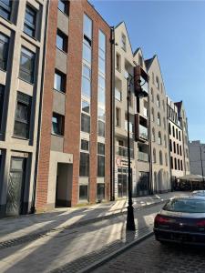 a car parked on a street in front of buildings at Apartament Stare Miasto 2 in Elblag