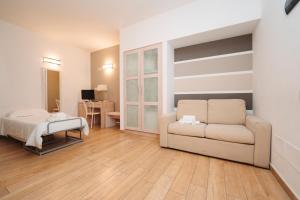 a living room with a couch and a bed at Hotel Di Nardo in Petacciato +13 photos
