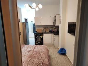 a small kitchen with a washing machine in a room at Aqua Palms Resort D101 in El Gouna +3 photos