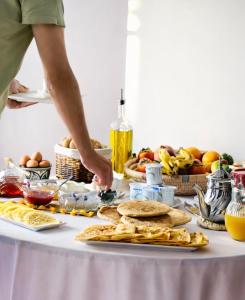 a table with a bunch of food on it at Riad Aïcha Addi Pool & Hammam in Essaouira