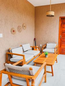 a room with three beds and a table and chairs at Icaraizinho House in Icaraí