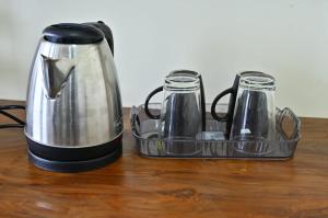 a toaster and coffee pot sitting on a table at RK Comforts in Belūr