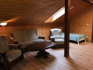 a living room with chairs and a table and a bed at Świerkowe Wzgórze in Grabków +57 photos