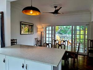 a kitchen and dining room with a table and chairs at Sensitively restored spacious apartment in Durban
