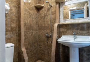 a bathroom with a shower and a sink and a toilet at Liva Mare - Serifos in Livadakia +47 photos