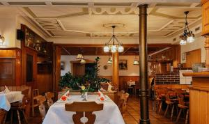 a dining room with a table and chairs at Hotel Restaurant Zum Hirschen in Donaueschingen