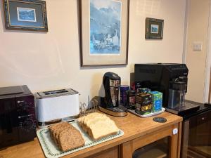 a counter with bread and a coffee maker and a toaster at Were House Warminster in Warminster