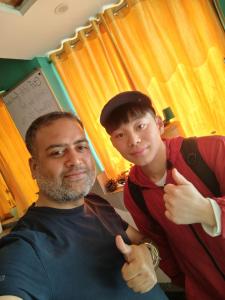 a man giving another man a thumbs up at Bedweiser Backpackers Hostel in Agra +98 photos