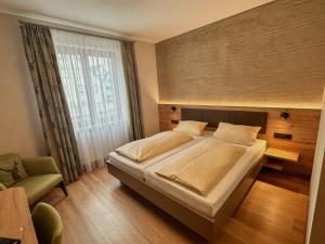 a bedroom with a large bed and a window at Hotel Restaurant Zum Hirschen in Donaueschingen