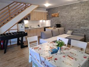 a living room with a table and a piano at Kuća za odmor MARE in Lepoglava