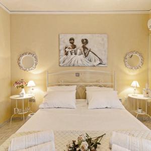 a bedroom with a bed with a painting on the wall at Erofili's Apartment ONLY 700 meters from the beach in Ialysos