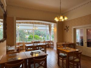 a restaurant with tables and chairs and a large window at The Raincliffe Hotel in Scarborough