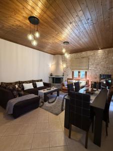 a living room with a couch and a table at Septem Mountain House in Eptalofos