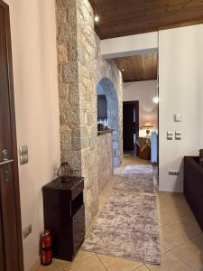 a hallway in a house with a stone wall at Septem Mountain House in Eptalofos