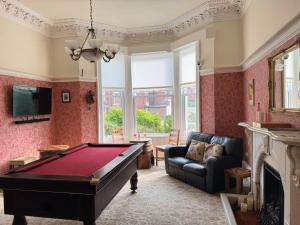 a living room with a pool table and a couch at The Raincliffe Hotel in Scarborough