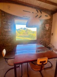 a dining room with a table and a window at GinTonic Rancho in San Luis