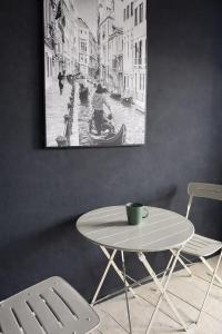 a table and chairs in a room with a picture on the wall at Free Way Kata Beach Hostel in Kata Beach +20 photos