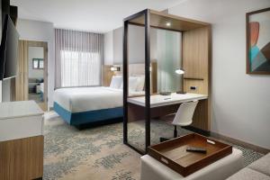 a hotel room with a bed and a mirror at SpringHill Suites by Marriott Locust Grove in Locust Grove +9 photos
