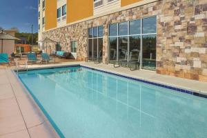 a swimming pool in front of a building at SpringHill Suites by Marriott Locust Grove in Locust Grove