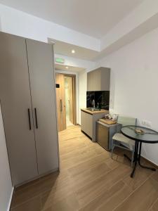 a kitchen with a table and a table and a room at Mare Studio by All Around in Heraklio