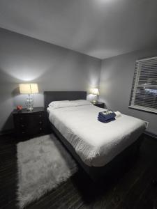 a bedroom with a bed and two night stands and a window at Cozy MasterRoom Gresham Park in Atlanta