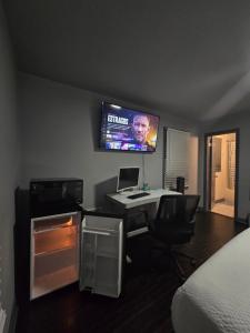 a room with a desk with a computer and a tv on the wall at Cozy MasterRoom Gresham Park in Atlanta