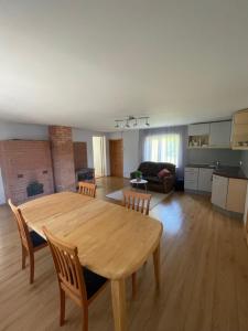 a large living room with a wooden table and chairs at Mihkli majutus in Rootsiküla +5 photos