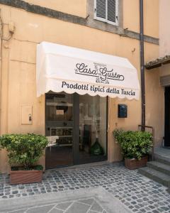 a store with awning on the side of a building at Guest house IL VICOLO in Caprarola