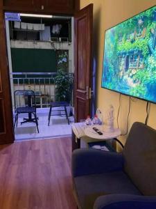 a living room with a tv and a couch and a table at Ribi Home in Hà Ðông +12 photos