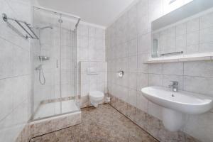 a bathroom with a shower and a sink and a toilet at Nord Jastarnia in Jastarnia