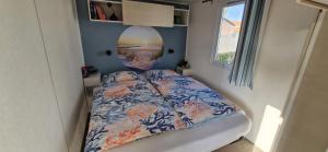 a bedroom with a bed in a small room at Chalet B2 900 m vom Strand in Koudekerke
