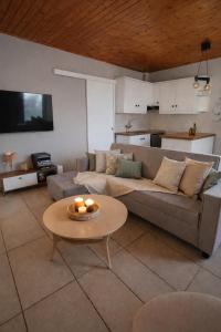 a living room with a couch and a table at Nafplio Cottage-Grandma's Yard in Asíni