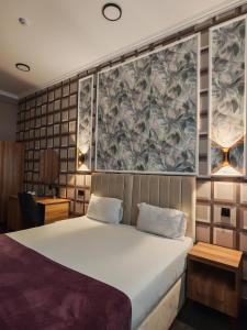 a bedroom with a bed and a wall with flowers at Will Hotel in Baku +92 photos