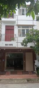 a white building with a raisin home sign on it at Ribi Home in Hà Ðông