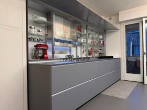 a kitchen with a long counter and a window at Cortirola luxury apartment in Pesaro