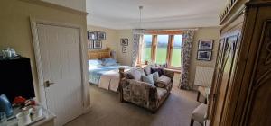 a bedroom with a bed and a chair and a window at Hay Farm House in Ford