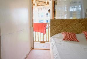 a bedroom with a bed and a door to a balcony at Nana's House in San Isidro