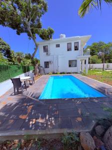 a swimming pool in front of a house at Cool Breeze Villa No 2 in Grand-Baie