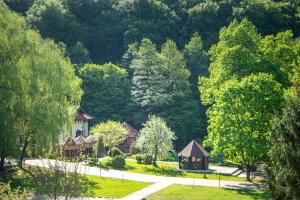 a house in the middle of a park with trees at Bogolvar Retreat Resort - Курорт для усамітнення "Богольвар" in Antalovtsi