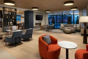 a lobby with a waiting area with chairs and tables at Element by Marriott Seattle Downtown in Seattle