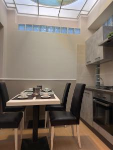 a dining room with a table and chairs in a kitchen at B&B Sorgenti del Gari in Cassino +17 photos