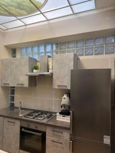 a kitchen with stainless steel appliances and a skylight at B&B Sorgenti del Gari in Cassino