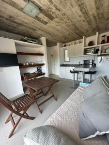a room with a bed and a table and a kitchen at Arenas Garzón in José Ignacio +16 photos