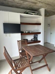 a wooden table and a chair in a room at Arenas Garzón in José Ignacio