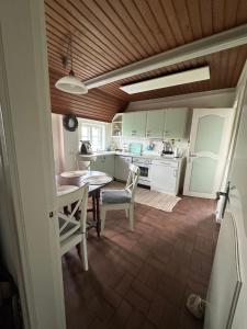 a kitchen with a table and chairs in a room at Deichbrise in Aventoft +13 photos